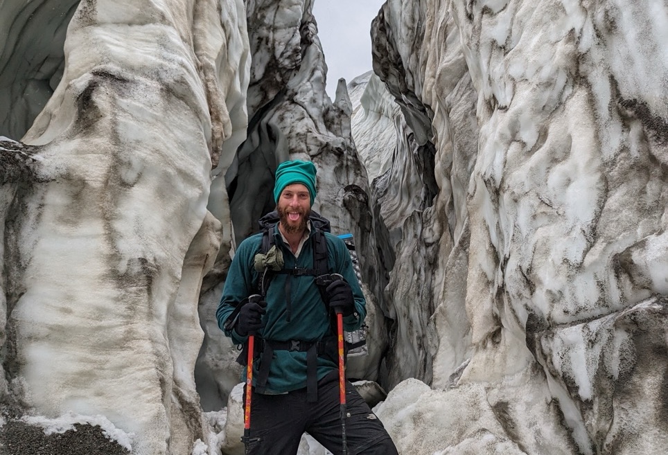 hiker in a snow tunnel in Kyrgyzstan 